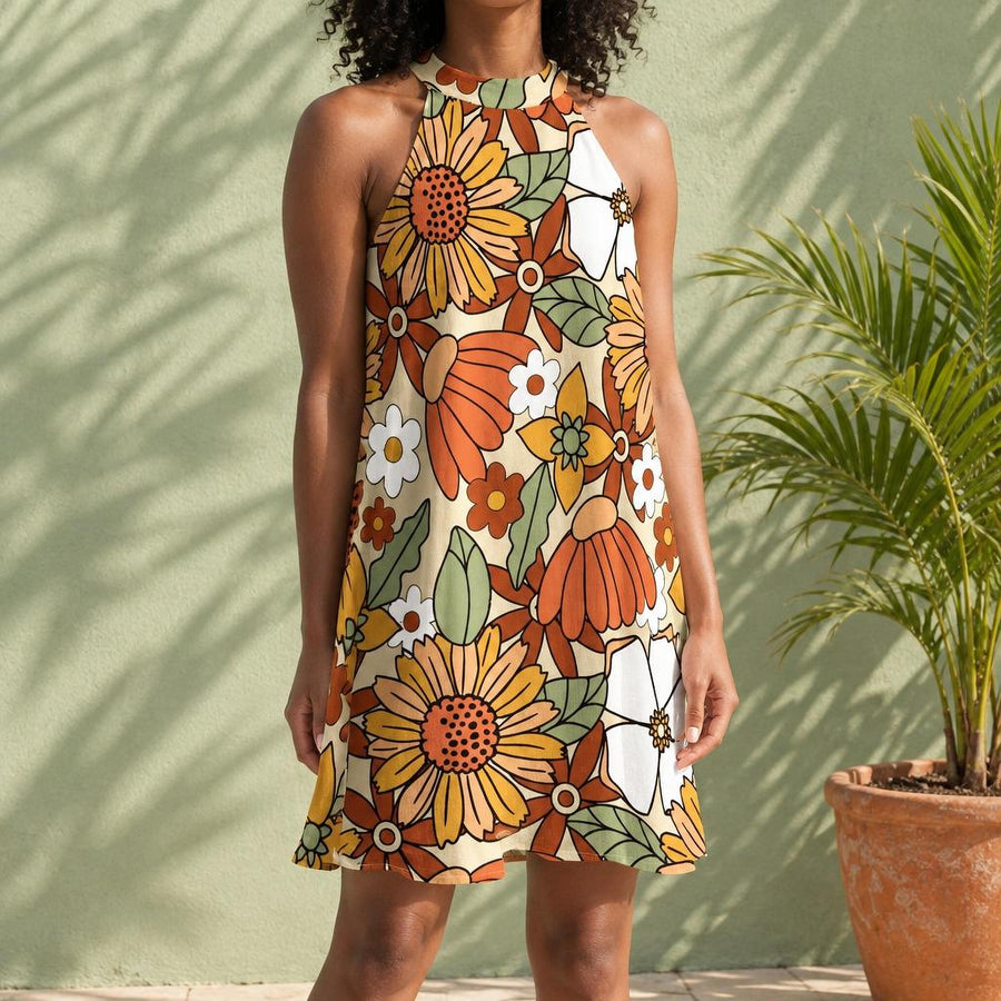 Rustic Blooms Halter Dress worn against a sage green garden wall with a palm in a terracotta pot