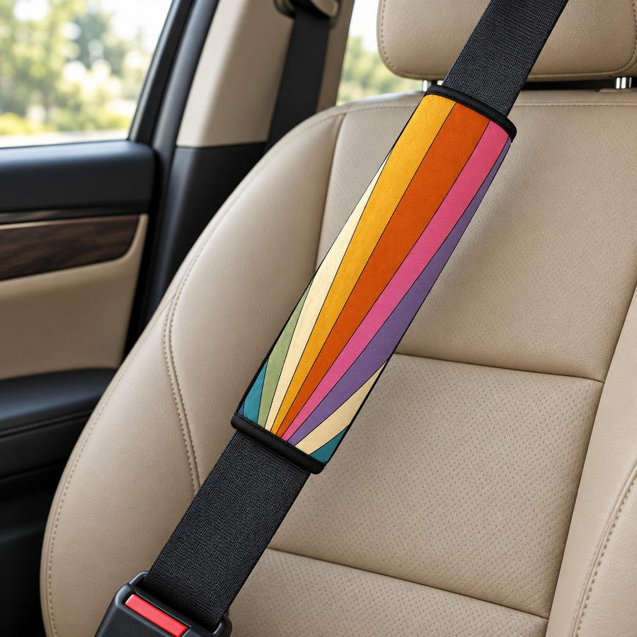 Retro Sun Rays Seat Belt Covers (Set of 2) wrapped around a car seat belt across a tan leather front seat