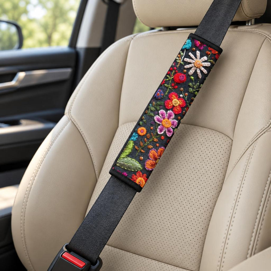 Felt Flowers Seat Belt Covers (Set of 2) wrapped around a car seat belt across a tan leather front seat