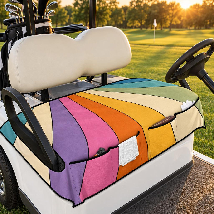 Retro Rainbow Golf Cart Seat Cover with front pockets, fitted on a white golf cart on a fairway at golden hour