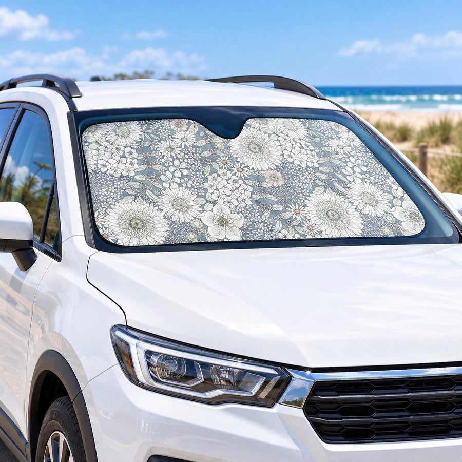 Snowy Field Of Flowers Car Shade fitted in the windscreen of a white SUV parked at a sunny beach, printed side facing out