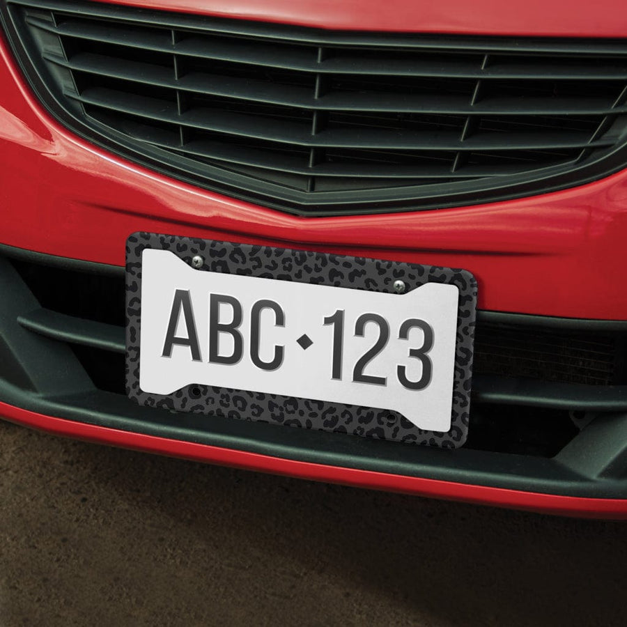 Black Leopard License Plate Frame on the front of a red car