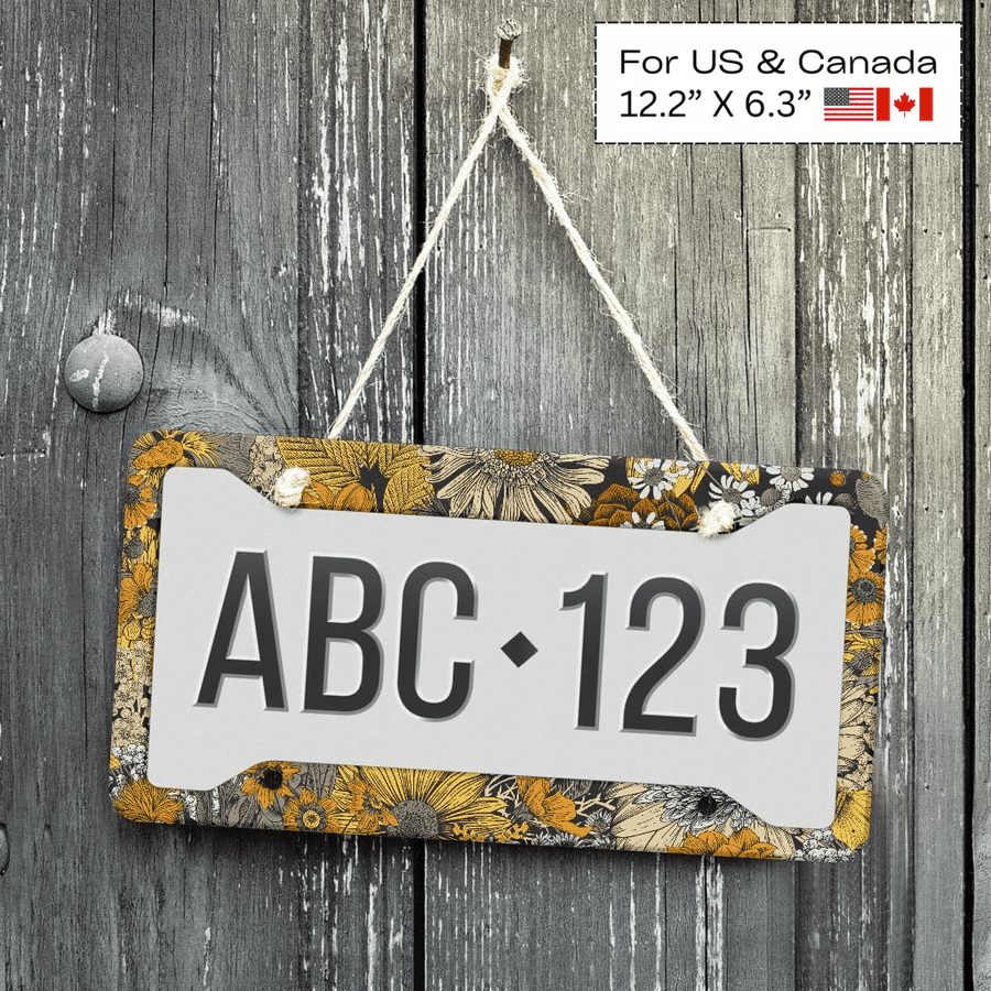 Fall Flowers License Plate Frame displayed on a wooden wall