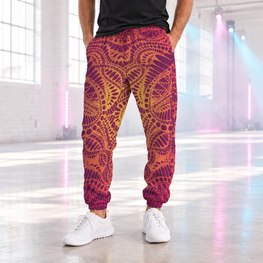 Fire Spirit Men's Track Pants worn with white sneakers in a bright daytime warehouse rave space with pastel stage lights