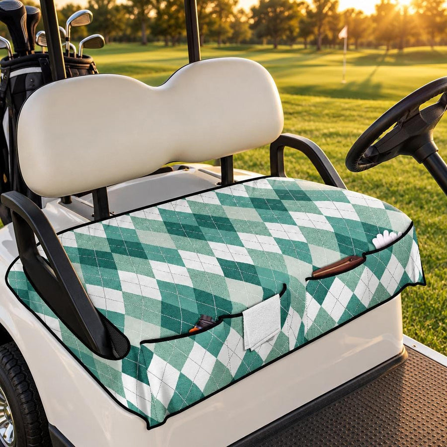 Green Argyle Golf Cart Seat Cover with front pockets, fitted on a white golf cart on a fairway at golden hour