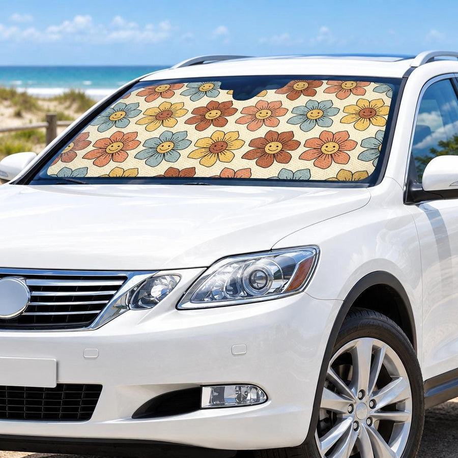 Smiling Flowers Car Shade fitted in the windscreen of a white SUV parked at a sunny beach, printed side facing out