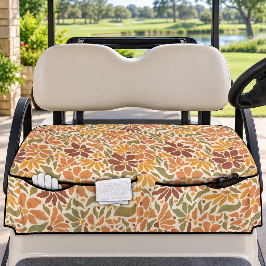 Boho Peach Paisley Golf Cart Seat Cover with front pockets, fitted on a white golf cart on a fairway