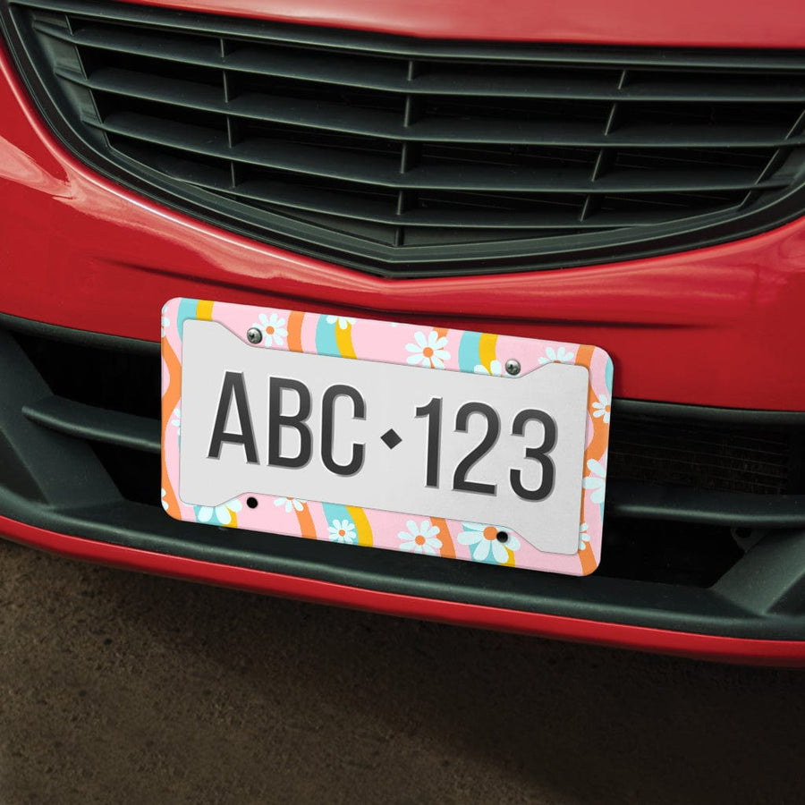 Pastel Pink Groovy Flowers License Plate Frame on the front of a red car