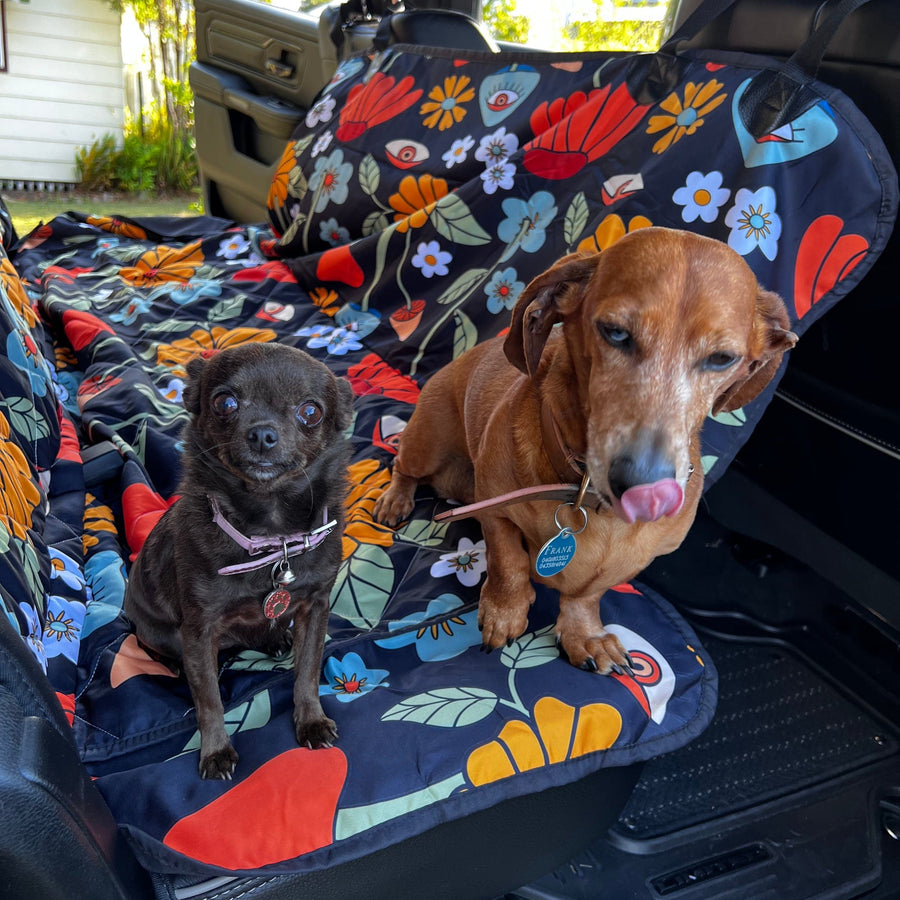 Hippie Mushroom On Black Dog Car Seat Covers with a dog sitting on it in a car